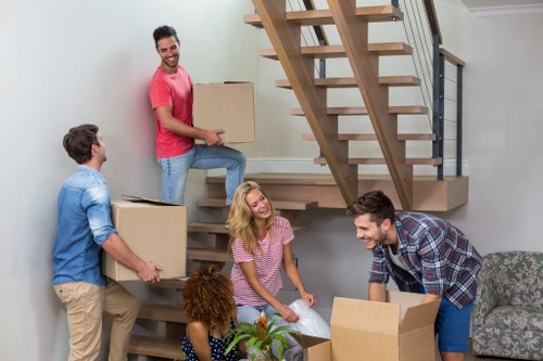 Moving van and removal team preparing a home move in Childshill