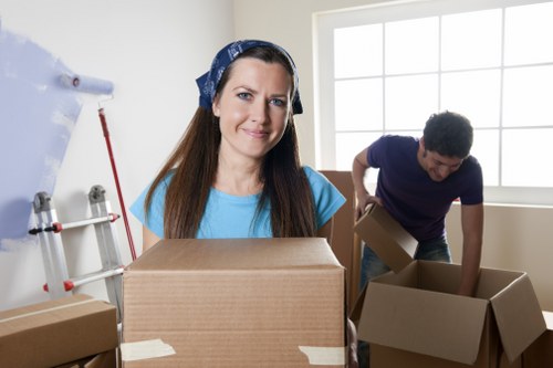 Trained movers in Childshill handling furniture carefully during loading